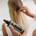 girl coming product into hair