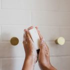 girl holding soap in shower
