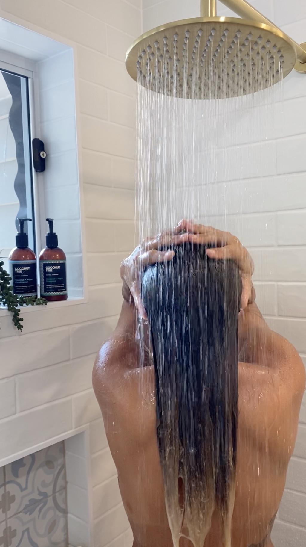 girl washing hair in shower